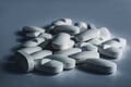 Closeup of many white prescription drugs, medicine tablets or vitamin pills in a pile - Concept of healthcare, opioids addiction