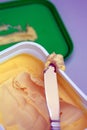Closeup of a margarine container and knife Royalty Free Stock Photo