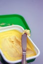 Closeup of a margarine container and knife