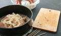 Closeup marinated shashlik from chicken meat in a pan, close up. And the onions on top.