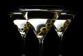 Closeup Martini drinks with olives on stick isolated on black Royalty Free Stock Photo