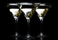 Closeup Martini drinks with olives on stick isolated on black Royalty Free Stock Photo