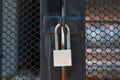 Closeup, master key silver lock on the black iron door. Royalty Free Stock Photo