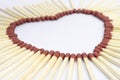 Closeup of match sticks arranged to form a heart shape