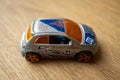 closeup of Mattel Hot Wheels toy model Fiat Seicento car on wooden surface.