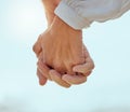 Closeup of a mature couple holding hands and enjoying a romantic stroll together on vacation at the beach. Older couple Royalty Free Stock Photo