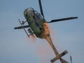 Closeup of MBB Bo105 helicopter releasing paint in the sky at an air show in Slovakia