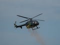 Closeup of MBB Bo105 helicopter releasing paint in the sky at an air show in Slovakia