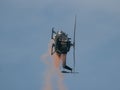 Closeup of MBB Bo105 helicopter releasing paint in the sky at an air show in Slovakia