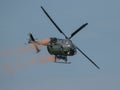 Closeup of MBB Bo105 helicopter releasing paint in the sky at an air show in Slovakia