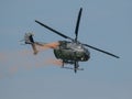 Closeup of MBB Bo105 helicopter releasing paint in the sky at an air show in Slovakia