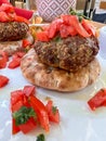 Closeup meatballs served on pita bread with tomato salad on plate