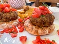 Closeup meatballs served on pita bread with tomato salad on plate