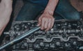 Closeup of a mechanic fixing an internal combustion engine Royalty Free Stock Photo