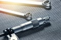 A closeup of a mechanical micrometer and open-end wrenches Royalty Free Stock Photo