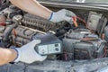 A closeup of a mechanics hands using jumper cables on a car battery. checking of car battery Royalty Free Stock Photo