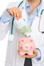 Closeup on medical doctor putting 100 euros note i Royalty Free Stock Photo