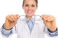 Closeup on medical doctor woman giving eye glasses