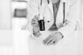 Closeup on medical doctor woman showing medicine bottle Royalty Free Stock Photo