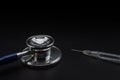 Closeup medical stethoscope and Insulin syringe to use control blood sugar level on black background. Use as Medicine, diabetes,