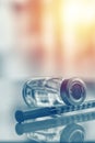 Closeup of medicine vial or flu, measles vaccine bottle with syringe and needle for immunization on vintage medical background,