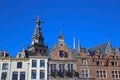 Closeup of medieval gabled house facades with church tower against blue summer sky - Nijmegen, Netherlands
