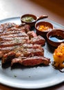 closeup medium rare ribeye steak on wood table