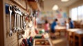 Closeup medium shot on wallmounted tool rack with tools hanging neatly while background shows blurred students Royalty Free Stock Photo