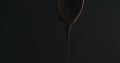 Closeup melted dark chocolate dripping from spoon over black background Royalty Free Stock Photo