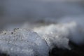 Closeup of melted snow on the ground in a blanket of pristine white snowflakes