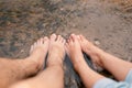 Closeup Men`s feet and women`s feet soaked in stream water Royalty Free Stock Photo