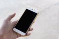 Closeup of ma hands, businessman holding a smartphone with a clean white screen and a black screen with a mockup design Royalty Free Stock Photo