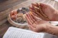 Men`s hands of prayer with wooden beads in sunlight, iftar concept, Ramadan month Royalty Free Stock Photo