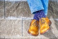 Closeup of Mens Legs Wearing Brown Oxfords Semi Brogues Shoes. Posing Outdoors Against Stony Grunge Background Royalty Free Stock Photo