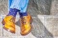 Closeup of Mens Legs Wearing Brown Oxfords Semi Brogues Shoes. Posing Outdoors Against Stony Grunge Background Royalty Free Stock Photo
