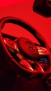 Closeup of a Mercedes-Benz AMG G63 steering wheel on red studio light