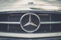 Closeup of Mercedes Benz logo design / brand name on front grill