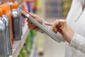 Closeup of merchandiser using tablet in shop