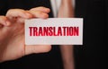 Translation word on card in hand of businessman. Global business concept