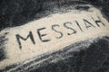 Closeup of MESSIAH text written on white sand Royalty Free Stock Photo