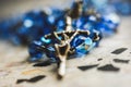 Closeup of a metal cross with jesus blue glass rosary