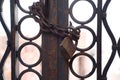 Closeup metal door locked with a chain and a rusty padlock Royalty Free Stock Photo