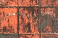 Closeup of metal doors, rusting and peeling red paint