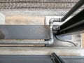 Closeup of the metal drain pipe along the footpath of the bridge