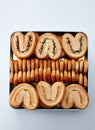 Closeup metal gift box full of biscuits, on white background