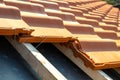 Closeup Of Metal Montage Anchor For Installation Of Yellow Ceramic Roofing Tiles Mounted On Wooden Boards Covering Residential