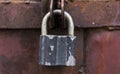 Closeup metal red grunge door with silver lock in grungy style and good texture. Royalty Free Stock Photo