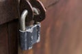 Closeup metal red grunge door with silver lock in grungy style and good texture. Royalty Free Stock Photo