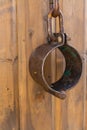 Closeup metal shackles vertical photo on wooden wall. The arrest of the criminal handcuffed shackle