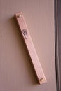 Closeup of a mezuzah on a doorpost